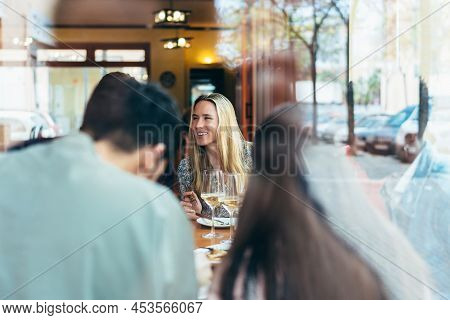 Caucasian Woman Seen Through A Glass Window Inside A Restaurant