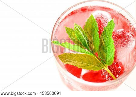 Raspberry Pink Drink.ice Cubes With Raspberries In A Glass With Water, Berries And Raspberry Leaves 