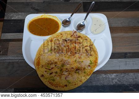 Uttapam Is Served With Chutney On White Plate, Indian Vegetable Dish.
