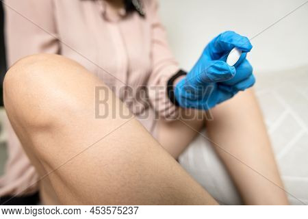 Hand Of Lady Girl Holding A Tablet Of Vaginal Suppository,preparing To Insert The Pill Into The Vagi