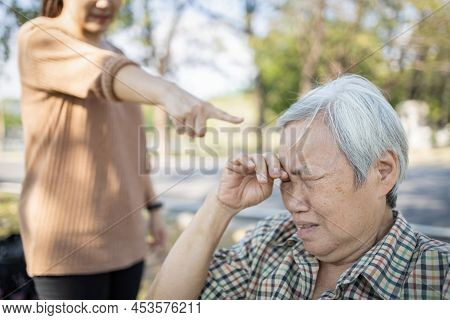Asian Elderly People Crying While Young Caregiver Scolding,angry Annoyed Woman Getting Mad Pointing 
