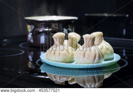 Georgian Dampling Known As Khinkali In Georgian On Black Plate On Black Background