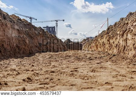 Dig A Trench. Earthworks, Digging Trench. Long Earthen Trench Dug To Lay Pipe Or Optical Fiber. Cons