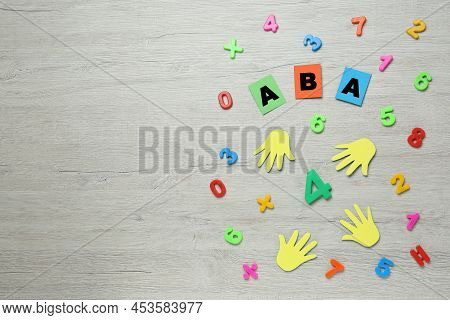 Flat Lay Composition With Abbreviation Aba (applied Behavior Analysis) And Colorful Numbers On White