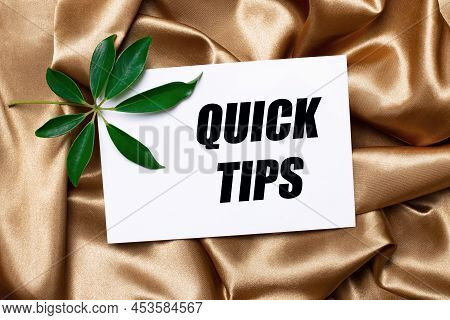 On Beautifully Curved Golden Silk Lies A Shefflera Sheet And A White Card With The Text Quick Tips