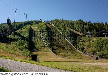 Harrachov, Czech Republic - August 21, 2020: Ski Jump Slopes In Harrachov During The Summer Covered 