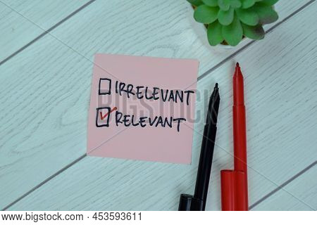 Virrelevant Versus Concept Of Relevant Write On Sticky Notes Isolated On Wooden Table.