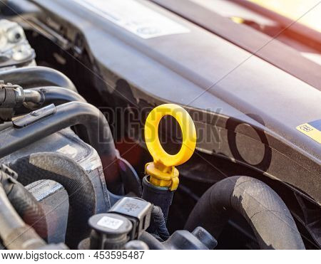 Orange Dipstick For Checking The Oil Level In A Diesel Engine. Concept Of Oil Viscosity And Quality,