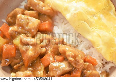 Chicken Curry With Fried Egg Topping On Rice In Bowl