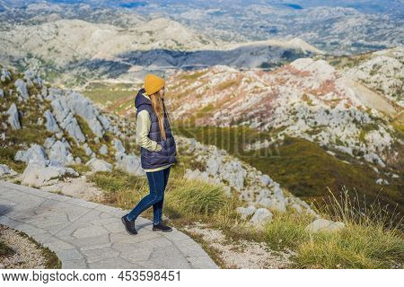 Woman Traveller In Mountain Landscape At National Park Lovcen, Montenegro. Travel To Montenegro Conc