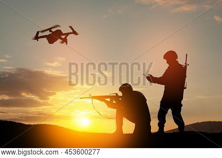 Silhouettes Of Soldiers Are Using Drone And Laptop Computer For Scouting During Military Operation.