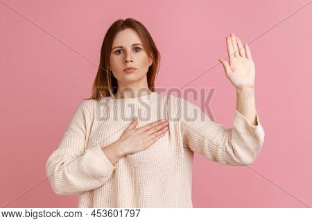 Portrait Of Honest Blond Woman Standing With Promise Hand Sign, Gesturing Palm Up, Giving Promise, P
