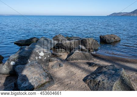 Boulders As A Part Of A Wave Breaker In A Lake. Picture From Lake Vattern, Sweden. Blue Water And Sk
