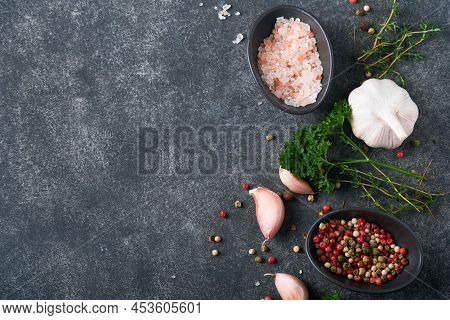 Black Food Cooking Background. Stone Texture With Sea Salt, Pepper Garlic And Parsley. Abstract Food
