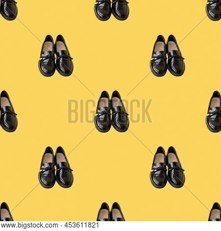 Pattern Black Shiny Lacquered Loafers With Bows On A Yellow Background.