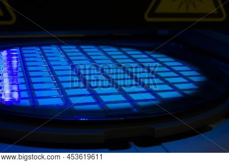 Silicon Wafer With Chips In Uv Lighting. Neon. Ultraviolet Lithography.