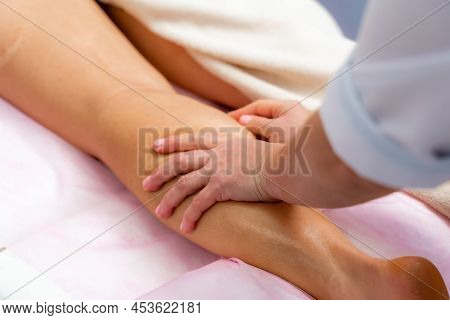 Facial Massage. A Woman Is Given A Massage In A Beauty Salon. Close-up.