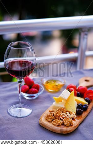 Two Glasses Of Wine And Cheese Plate. Aperetif.