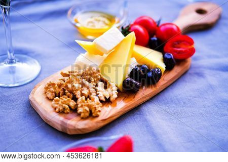 Two Glasses Of Wine And Cheese Plate. Aperetif.