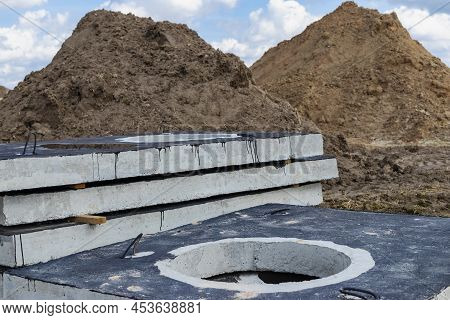 Reinforced Concrete Slabs At A Construction Site Against A Blue Cloudy Sky And Earth. Folded Plates 