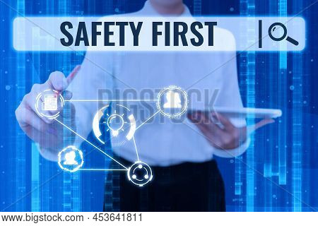 Hand Writing Sign Safety First. Word For Avoid Any Unnecessary Risk Live Safely Be Careful Pay Atten