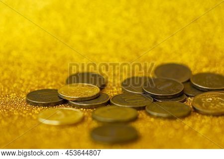 Ruble Coin Close-up. A Group Of Scattered Coins On A Shiny Gold Background. Savings. The Concept Of 