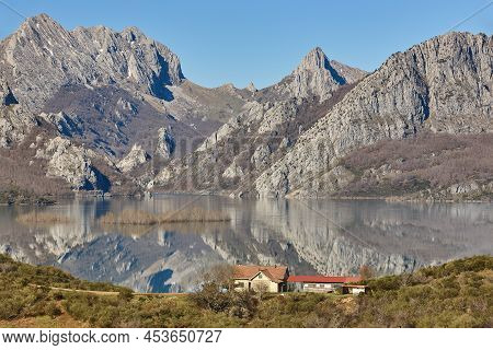 Picturesque Reservoir And Mountain Landscape In Riano. Mirror Effect. Spain