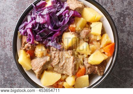 Scouse Is A Stew With Meat And Vegetables Served With Pickled Cabbage Close-up In A Plate On The Tab