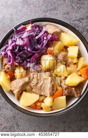 English Scouse Is A Beef Or Lamb Stew With Vegetable Closeup In The Plate On The Table. Vertical Top