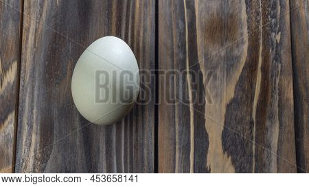 Araucana Egg On Wooden Background. Light Blue Egg From Araucana Chicken. Easter Festival Concepts. E