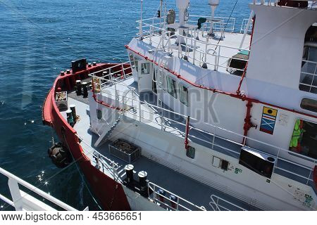 Red Hulled Standby Safety Vessel In Ship To Ship Operation. It Is Used To Refuel And Resupply Seismi