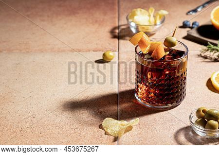 Vermouth Cocktail With Appetizer Isolated On Red Background With Copy Space. Typical Spanish Appetiz