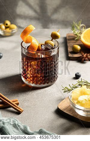 Vermouth Cocktail With Snacks And Ingredients On Concrete Background. Vertical Format. Typical Spani