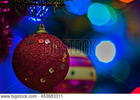 A Red Christmas Ball Hanging On The Christmas Tree.