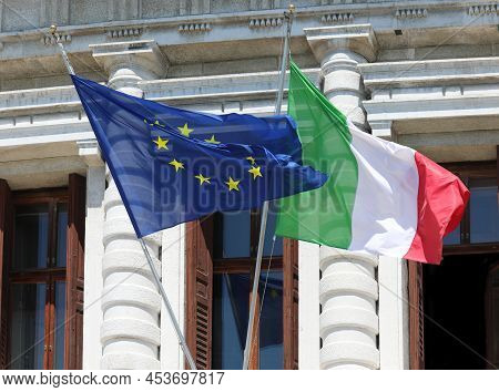 Two Large European And Italian Flags During The International Meeting In The Historic Building