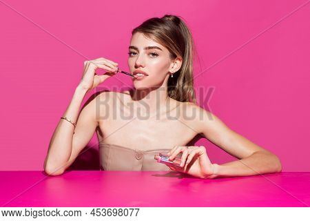 Young Woman Applies Pink Lipstick On Lips. Close-up Beauty Portrait Of Attrctive Cute Sensual Young 