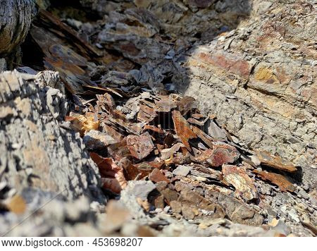 Geodesy. Stone Texture. The Rock Is Brown And Red. Mineral Background. Design From Natural Materials