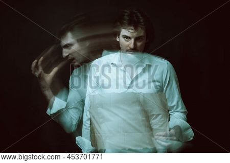 Schizophrenic Blurred Portrait Of Psychopathic Man With Mental Disorders And Disorders On Dark Backg