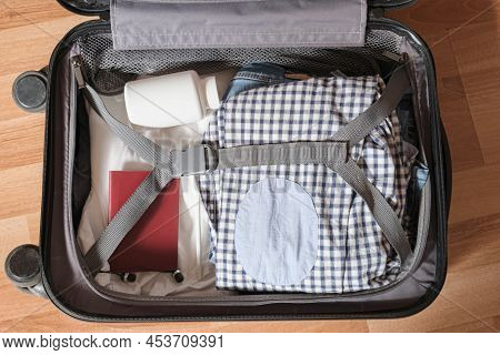 Things Folded In A Suitcase For Hand Luggage On A Business Trip - Clothes, Medicines, Passport
