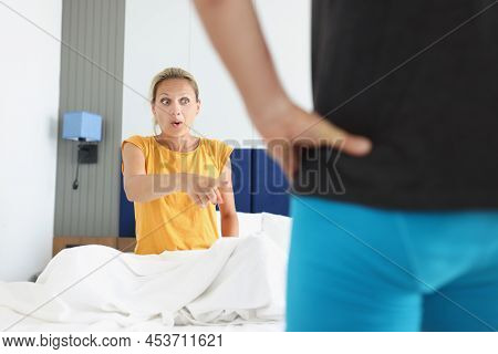 Shocked Woman Pointing Finger At Man In Shorts. Intimate Life And Sex In Relationships Concept