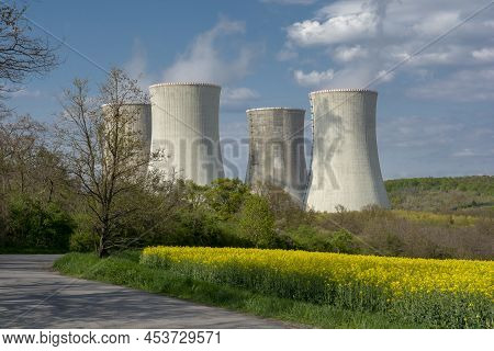 Cooling Towers Of Nuclear Power Plant With The Yellow Field Of Rapeseed, Canola Or Colza. Mochovce. 