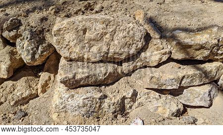 Large Gray-yellow Stones In The Spring Lying On The Seashore Sunny Yellow Color Warm Background