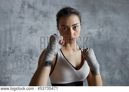 Chest Up Portrait Of Strong Young Woman With Handwraps Ready For Punching