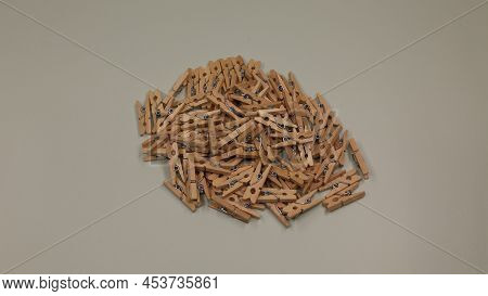 Small Wooden Clothespins For Decorating. Clothespins Made Of Wood. Bright Wooden Background