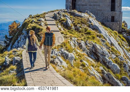 Couple Man And Woman Tourists In Mountain Landscape At National Park Lovcen, Montenegro. Travel To M