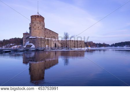Ancient Fortress Of Olavinlinna (olafsborg) In The March Evening Landscape. Savonlinna, Finland