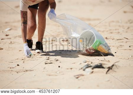 Cropped Image Of Female Volunteer Cleaning Beach From Plastic Waste