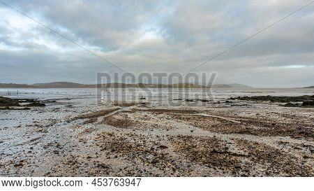 Stream Flowing Into Balcary Bay, With Salmon Fishing Nets In The Background, Auchencairn, Scotland