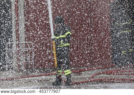 Spray Mist Of The Foam Used By The Firefighter To Put Out The Fire During An Exercise In The Barrack