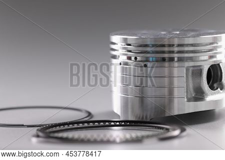Close-up Of Forcer And Piston Rings, Internal Combustion Engine On Grey Background. Car Details, Tra